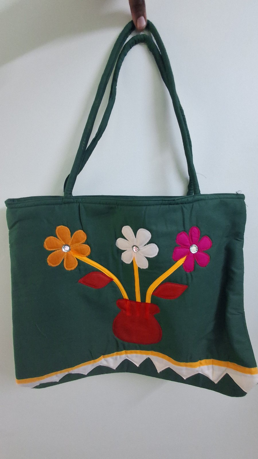 dark green handbag with flowers